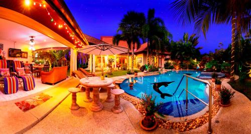 Relaxing Palm Pool Villa And Tropical Illuminated Garden And Swimming Pool.